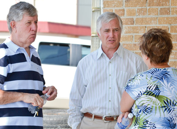 Danny Henderson, Bill Clinkscale and Lisa Cate visit in front of the service station at Henderson Oil & Propane this week. Henderson's family owned the business from 1946 until Clinkscale bought it 15 years ago. Cate is the manager.